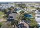 Aerial view features an expansive community with a pool, clubhouse, tennis courts, and numerous residences at 1115 Deer Creek Blvd, Davenport, FL 33837