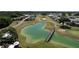Scenic aerial view of the golf course with a pond and wooden bridge at 1115 Deer Creek Blvd, Davenport, FL 33837