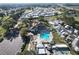 Aerial view showcases a community featuring a pool, clubhouse, and well-maintained green spaces at 1115 Deer Creek Blvd, Davenport, FL 33837