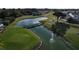 Scenic aerial view of the golf course with a pond and wooden bridge at 1115 Deer Creek Blvd, Davenport, FL 33837