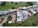 Aerial view of a home with an attached carport and additional back enclosed patio at 1115 Deer Creek Blvd, Davenport, FL 33837