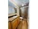 Bathroom featuring a vanity, toilet, and walk-in shower with glass doors at 1115 Deer Creek Blvd, Davenport, FL 33837