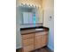 Bathroom with a wood vanity and a large mirror at 1115 Deer Creek Blvd, Davenport, FL 33837