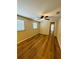 Bright bedroom with wood flooring, ceiling fan, and natural light from two windows at 1115 Deer Creek Blvd, Davenport, FL 33837
