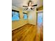 Bedroom featuring wood-look floors, a ceiling fan and a view into the hallway at 1115 Deer Creek Blvd, Davenport, FL 33837