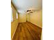 Cozy bedroom with wood-look flooring, ceiling fan, and two windows for natural light at 1115 Deer Creek Blvd, Davenport, FL 33837