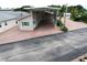 Exterior shot of home with covered carport, featuring a brick driveway and manicured landscaping at 1115 Deer Creek Blvd, Davenport, FL 33837