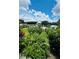 A well landscaped yard with green grass, a brick driveway, and an exterior of the home at 1115 Deer Creek Blvd, Davenport, FL 33837