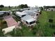 An exterior view of the home showcasing the carport, screened in patio, landscaping, and community at 1115 Deer Creek Blvd, Davenport, FL 33837