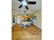 Open concept living area featuring wood floors, dining table, and access to the kitchen at 1115 Deer Creek Blvd, Davenport, FL 33837
