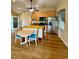 Living space with wood floors, kitchen island, stainless steel appliances, and natural lighting at 1115 Deer Creek Blvd, Davenport, FL 33837