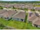 Aerial view of a well-maintained community with many single Gathering homes and green space at 1156 Cavender Creek Rd, Minneola, FL 34715