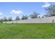 A large green backyard with a tall, private fence at 1156 Cavender Creek Rd, Minneola, FL 34715