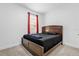 This bedroom features a large window and a dark wood-framed bed at 1156 Cavender Creek Rd, Minneola, FL 34715