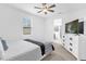 This bedroom features a ceiling fan and large windows for ample natural light at 1156 Cavender Creek Rd, Minneola, FL 34715