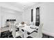 Bright dining room with a modern white table, six chairs and stylish pendant lighting at 1156 Cavender Creek Rd, Minneola, FL 34715