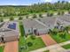Charming single-story home with manicured lawn, brick driveway, and stylish gray facade at 1156 Cavender Creek Rd, Minneola, FL 34715