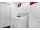 Bright laundry room with a washer, dryer and storage cabinets at 1156 Cavender Creek Rd, Minneola, FL 34715