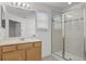 Well-lit bathroom featuring a glass shower, bright vanity, and tile flooring at 11837 Cave Run Ave, Windermere, FL 34786