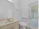 Bright bathroom with modern toilet and access door to outdoor area at 11837 Cave Run Ave, Windermere, FL 34786