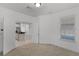 View from doorway of bright bedroom with carpet and a glimpse of the kitchen area at 11837 Cave Run Ave, Windermere, FL 34786