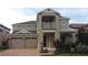 Two-story home featuring neutral stucco, a two-car garage, brick driveway, and a small balcony at 11837 Cave Run Ave, Windermere, FL 34786