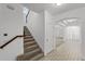 Hallway featuring tiled flooring and a staircase with carpet leading to the second floor at 11837 Cave Run Ave, Windermere, FL 34786