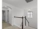 Second floor hallway with carpet flooring and a wooden railing overlooking the stairwell at 11837 Cave Run Ave, Windermere, FL 34786
