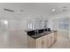 Bright kitchen with granite countertop bar overlooking the living area and stainless steel appliances at 11837 Cave Run Ave, Windermere, FL 34786