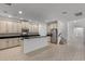 Stylish kitchen with white cabinetry, stainless steel appliances, and an island with a breakfast bar at 11837 Cave Run Ave, Windermere, FL 34786