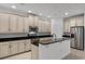 Kitchen boasts white cabinets, black countertops, stainless steel appliances, and a center island at 11837 Cave Run Ave, Windermere, FL 34786