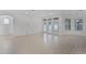 Open living area with large windows and glass doors, showcasing abundant natural light at 11837 Cave Run Ave, Windermere, FL 34786