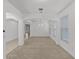Open concept living area with carpet, tile floors, white walls and many windows at 11837 Cave Run Ave, Windermere, FL 34786
