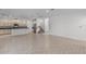Spacious living room with modern tile flooring flowing into an open kitchen area at 11837 Cave Run Ave, Windermere, FL 34786