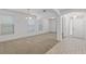 Spacious living room featuring carpeted floors, arched doorways, and lots of natural light at 11837 Cave Run Ave, Windermere, FL 34786