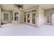 Covered patio featuring a ceiling fan and multiple access points to the indoors at 11837 Cave Run Ave, Windermere, FL 34786