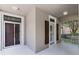 Inviting front porch with double doors and a glimpse of the well-maintained yard at 11837 Cave Run Ave, Windermere, FL 34786