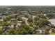 Aerial view of a residential neighborhood with mature trees, roads and houses, near a body of water at 1209 Russell Dr, Ocoee, FL 34761
