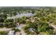 Aerial view of a neighborhood with a lake and tree-lined streets and houses at 1209 Russell Dr, Ocoee, FL 34761