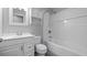 Bright bathroom featuring a white vanity with storage and a shower-tub combo with white subway tile surround at 1209 Russell Dr, Ocoee, FL 34761