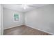 Bedroom featuring light walls, new flooring, and a bright window at 1209 Russell Dr, Ocoee, FL 34761