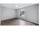 Bedroom featuring light walls, new flooring, ceiling fan, and a bright window at 1209 Russell Dr, Ocoee, FL 34761