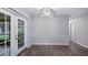Dining room with new flooring, modern light fixture, and French doors leading to the outdoors at 1209 Russell Dr, Ocoee, FL 34761