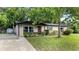 Charming single-story home with well-maintained lawn and mature tree in a peaceful residential neighborhood at 1209 Russell Dr, Ocoee, FL 34761