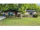 Inviting single-story home with a lush green lawn and mature landscaping at 1209 Russell Dr, Ocoee, FL 34761
