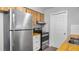 Kitchen featuring updated stainless steel appliances, subway tile backsplash, and butcher block countertops at 1209 Russell Dr, Ocoee, FL 34761
