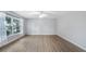 Bright living room with neutral walls, modern flooring, and a large window at 1209 Russell Dr, Ocoee, FL 34761