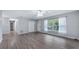 Bright living area with neutral walls, modern flooring, and a large window and door at 1209 Russell Dr, Ocoee, FL 34761