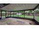 Screened porch with a concrete floor, overlooking the fenced backyard with a shed and mature trees at 1209 Russell Dr, Ocoee, FL 34761