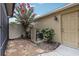 Charming backyard featuring a side door, lush greenery, and a well-kept air conditioning unit at 12884 Calderdale Ave, Windermere, FL 34786